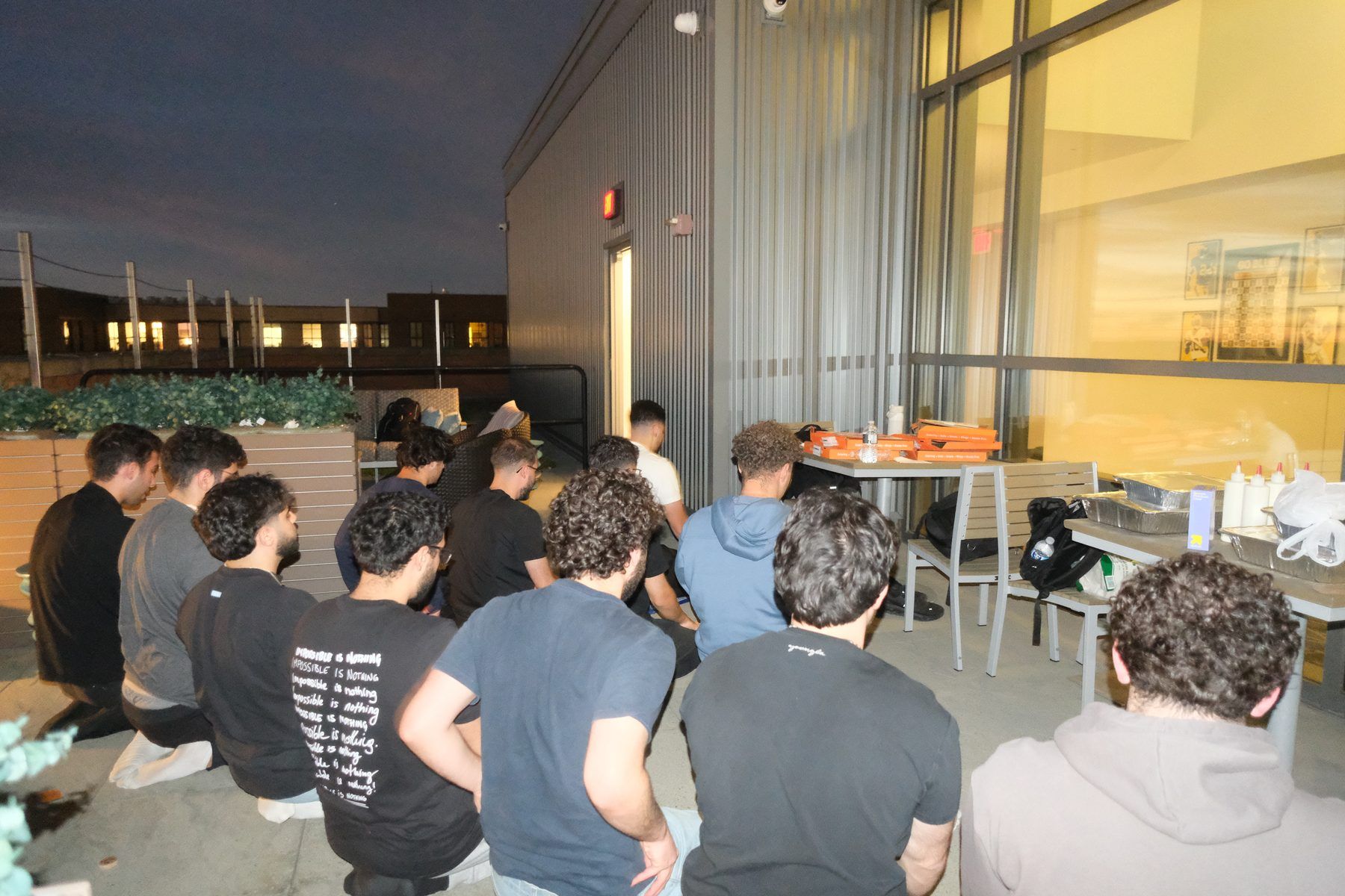 ISA members gathered on an outdoor terrace at dusk