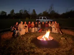 ISA members gathered around a campfire at night