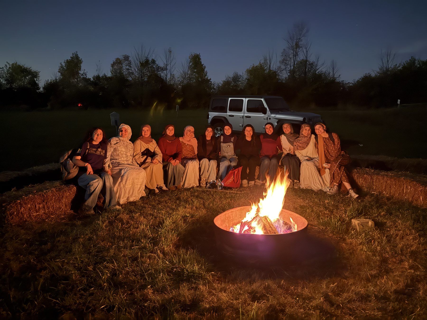 ISA members gathered around a campfire at night