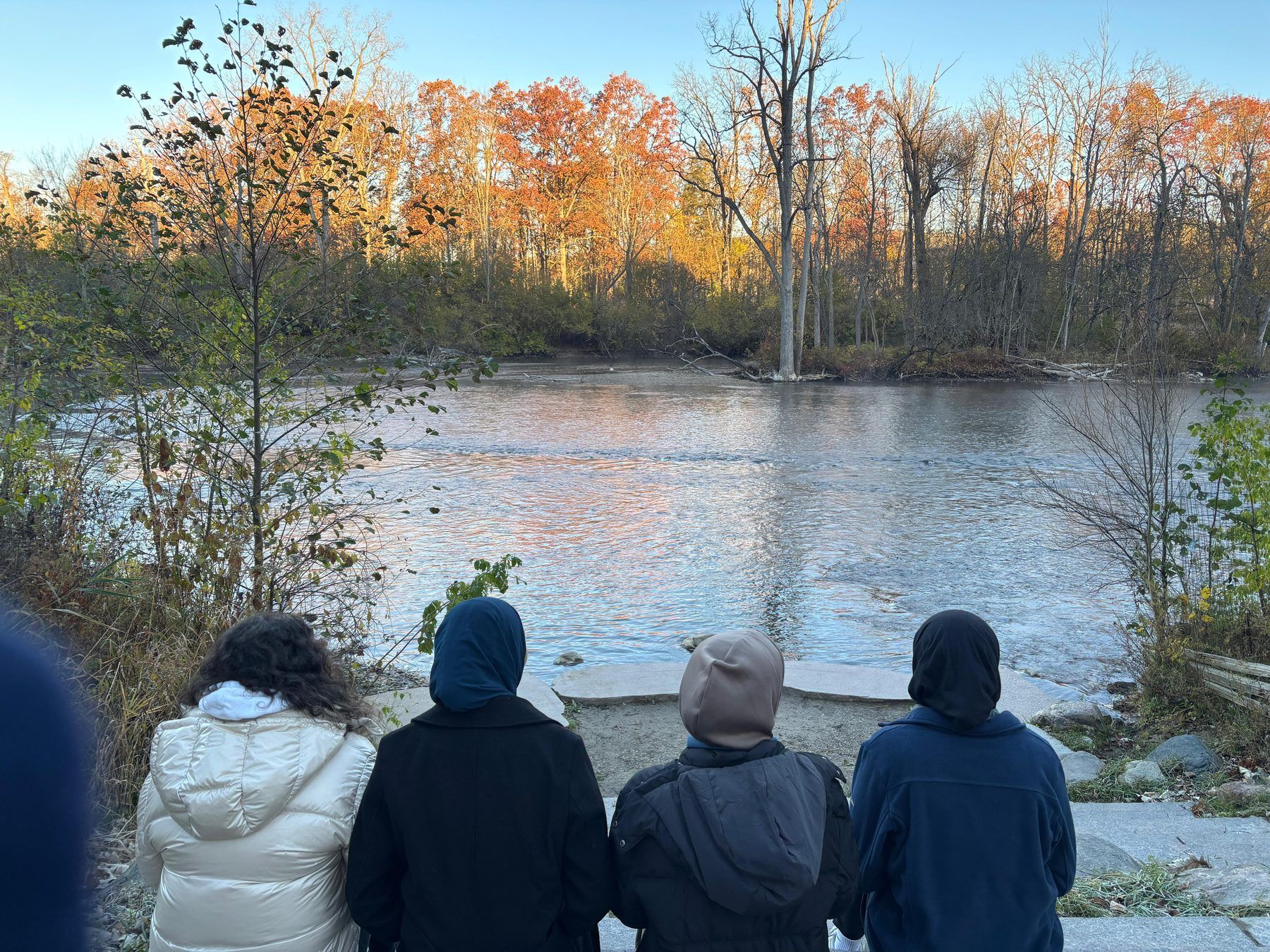 ISA members by a river on an autumn walk